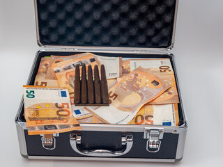 The bullet and money in euros are in the suitcase.