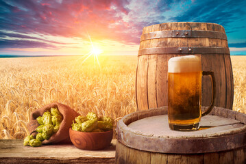 Beer brewing ingredients Hop in bag and wheat ears on wooden cracked old table. Beer brewery concept. Hop cones and wheat closeup. Sack of hops and sheaf of wheat on vintage background. - obrazy, fototapety, plakaty