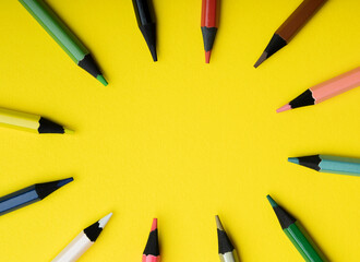 colored pencils on a yellow background