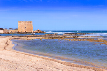 Torre Santa Sabina Beach in Apulia, Italy. The watchtower of Santa Sabina has star-shaped with four corners oriented to the cardinal points, with embattled crowning.