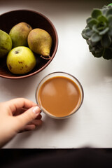 cup of coffee with pears in a bowl