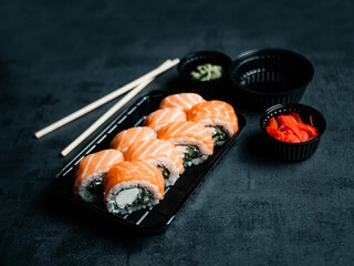 Sushi with chopsticks, ginger, wasabi and soy sauce. Selective focus