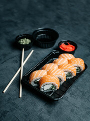 Sushi with chopsticks, ginger, wasabi and soy sauce. Selective focus