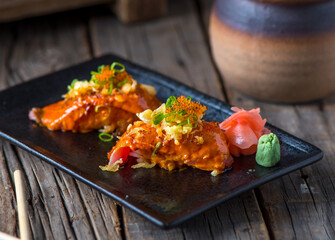 Tuna nigiri served in a dish isolated on wooden background side view of nigiri