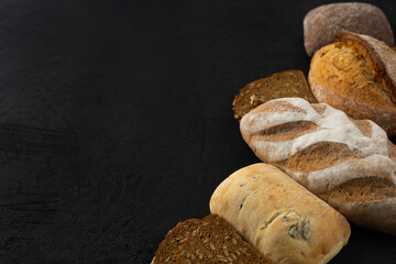 Different bread, gluten free, rye, multigrain on a black background