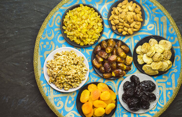 Ramadan celebration. Mix of dried fruits, dates and nuts. Top view with close up. Ramadan background with copy space.