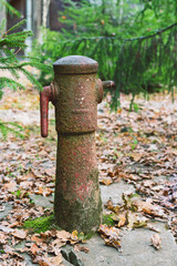 Fototapeta premium Old rusty and broken water tap in the park
