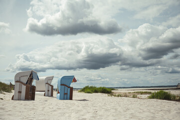 Sunny beach with white sand and wicker beach chair in north Germany