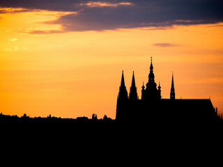 Beautiful landscape at sunset with the silhouette of the Prague Castle guarding the city