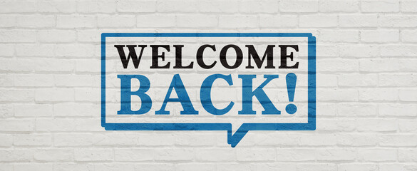 Obraz premium WELCOME BACK!とかかれたレンガ壁