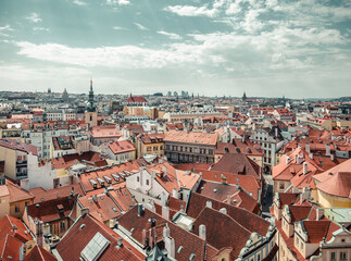 Beautiful aerial view with the city of Prague. Many traditional houses with red roof tiles.