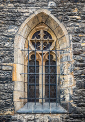 Architectural detail with a window of a church built in gothic medieval style