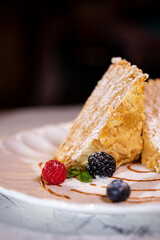 napoleon cake with berries. serving dessert in a restaurant