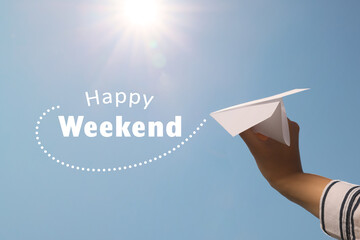 Happy Weekend. Woman holding paper plane against blue sky, closeup