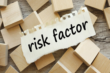 Risk factor - many cubes scattered and torn paper with text