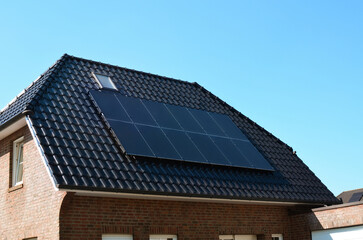 Naklejka premium Building with installed solar panels on roof. Alternative energy source