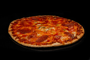 Burnt pizza with sausage, mushroom, pepper, cheese on tray in electric oven, black background. Italian cuisine, homemade bakery, fast food concept