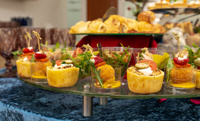 snacks and salads on the buffet table. catering at the event.