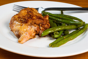 baked chicken thigh served with sauteed  green beans