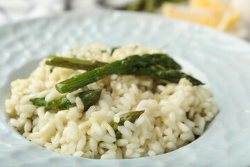 Delicious risotto with asparagus in plate, closeup