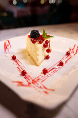 fresh New York cheesecake on a white plate with berries . serving dessert in a food restaurant photo