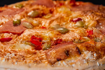 Burnt pizza with with sausage, mushroom, pepper, cheese in electric oven - close up, macro. Italian cuisine fast food, failure, problem concept