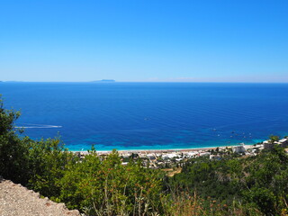 Obraz premium Dhermi, Albania, view from the rooftop restaurant on the seaside, public beach and mountains.