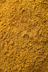 Aromatic turmeric powder as background, top view