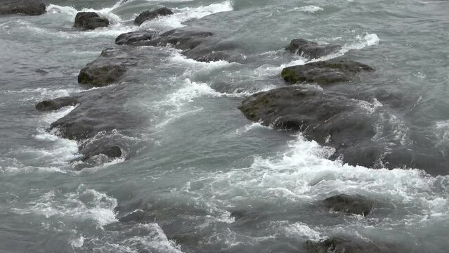 Fantastic landscape with flowing rivers and streams with rocks and grass in Iceland.