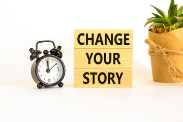 Change your story symbol. Concept words Change your story on wooden blocks on a beautiful white table white background. Black alarm clock. Business, finacial and change your story concept. Copy space.