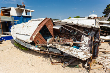 broken boats on the shore, Losinj town, Croatia.