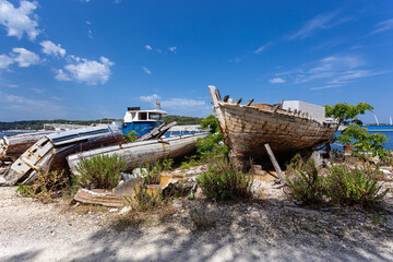 Fototapeta na wymiar broken boats on the shore, Losinj town, Croatia.