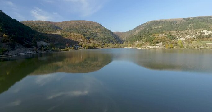 Aerial video of a lake in the mountains in autumn