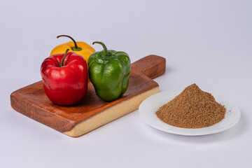 Rocoto, multicolor chili pods and chili powder on white table