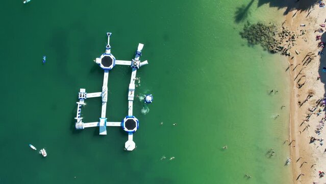 Aerial view of people playing at an inflatable water platform close to Duquesa Beach in Cascais, Portugal