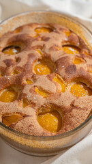 Close-up of Tasty peach pie on white textile background. Top view.