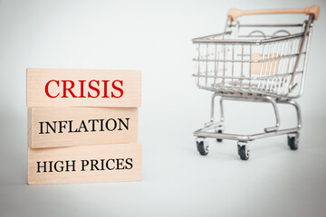 Slogans written on wooden blocks, Crisis, Inflation and high prices, Mini shopping cart, Concept, World economic problems