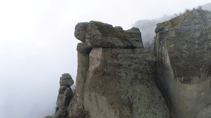 Aerial view on Mountains and rocks in fog. Shot. Foggy background with rocks
