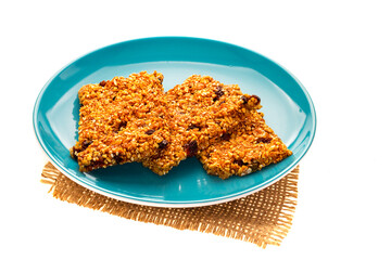 granola bars on ceramic plate isolated on white