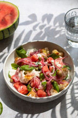 Summer salad with watermelon, buratta, basil and pickled onions