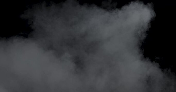 Soft fog haze on dark background. Realistic atmospheric gray smoke on black background. The White Smoke Rises Slowly. Abstract Fog cloud. Filmed with RED camera.