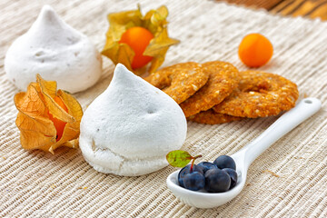 Meringue cookies and berries on the table