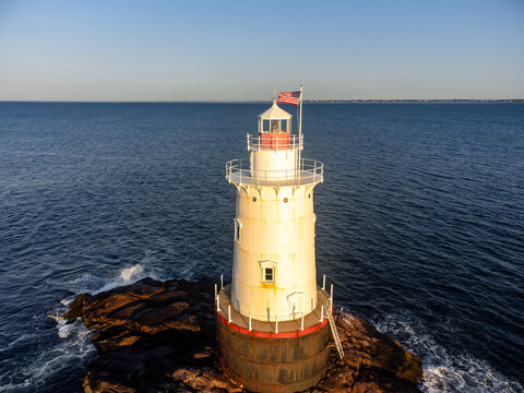 Early morning aerial image of the Sakonnet Point Light (West Island Light) between Little Compton and Tiverton Rhode Island, at Sakonnet River and Atlantic Ocean. 