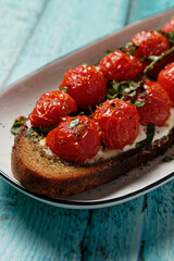 Healthy toast (tartine) with vine tomato branch. Close-up.