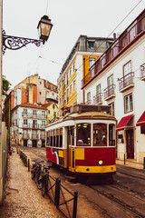 Fototapeta na wymiar Vintage tram in Alfama historical district of Lisbon, Portugal