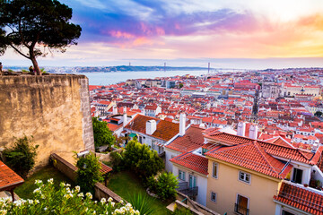 Beautiful panorama of old town Baixa district and Tagus River in Lisbon city during sunset, seen from Sao Jorge Castle hill, Portugal
