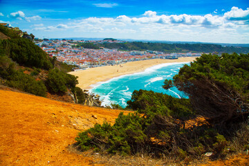Fototapeta na wymiar View of Nazare town and the sandy beach seen from high cliff, Portugal