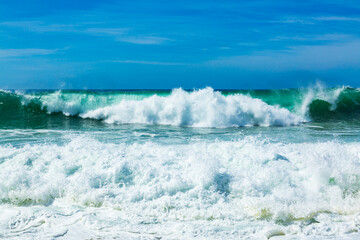 Big blue ocean waves with white foam
