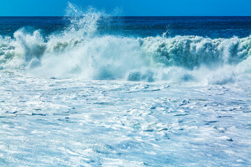 Big blue ocean waves with white foam