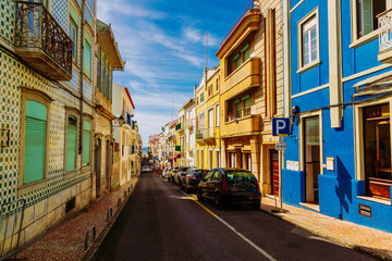 Fototapeta premium Colorful street going down to the Atlantic Ocean in Nazare town, Portugal
